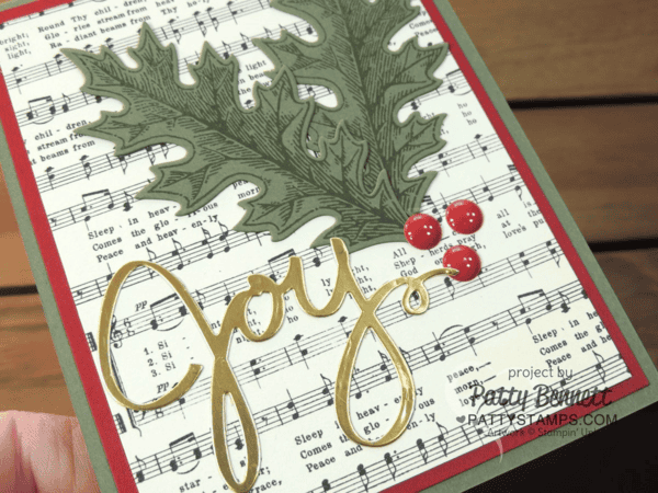 Handmade Christmas card featuring muscial score paper from Stampin' Up! - Home for Christmas paper pack. Joy die cut from Wonderful Wreath framelits and Gold Foil Paper. Card accented with Red Enamel Dots, by Patty Bennett