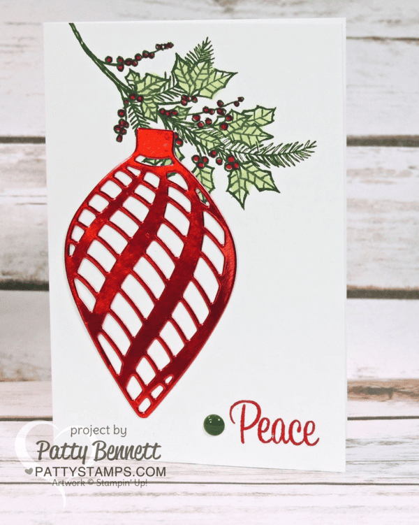 Create a handmade Christmas Card with red foil accents, using the Stampin Up! delicate ornaments dies. Stamp the holly sprig using the Peaceful Wreath stamp set. Color in with Blender Pens. Card by Patty Bennett Create a handmade Christmas Card with red foil accents, using the Stampin Up! delicate ornaments dies. Stamp the holly sprig using the Peaceful Wreath stamp set. Color in with Blender Pens. Card by Patty Bennett