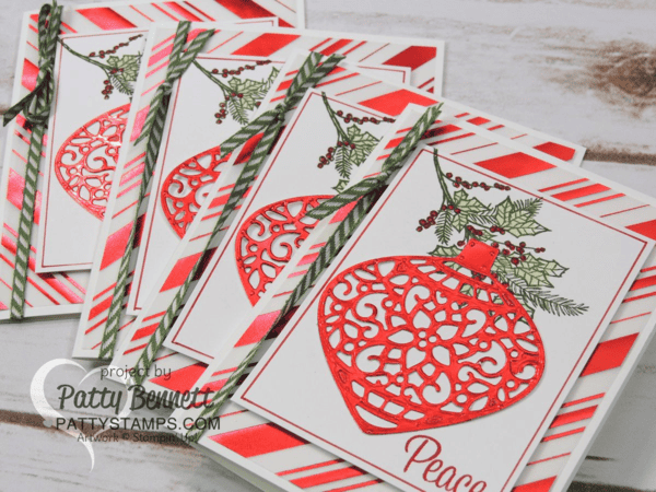 Create a handmade Christmas Card with red foil accents, using the Stampin Up! delicate ornaments dies and red striped vellum paper background. Stamp the holly sprig using the Peaceful Wreath stamp set. Color in with Blender Pens. Card by Patty Bennett Create a handmade Christmas Card with red foil accents, using the Stampin Up! delicate ornaments dies and red striped vellum paper background. Stamp the holly sprig using the Peaceful Wreath stamp set. Color in with Blender Pens. Card by Patty Bennett