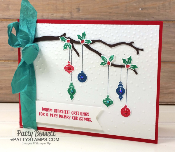 Carols of Christmas Stampin' Up! bundle card idea with hanging ornaments, softly falling embossing folder, and die cut branch from the Seasonal Layers framelits. By Patty Bennett