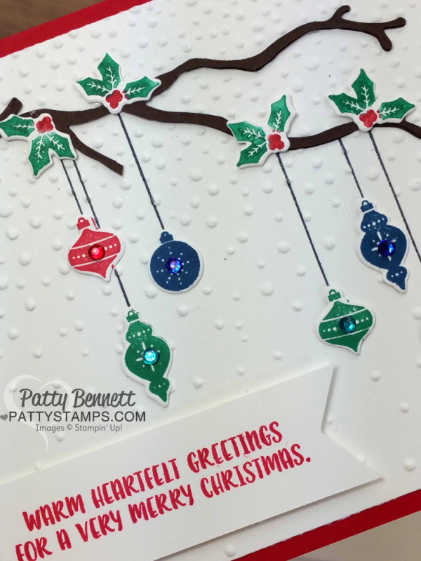 Carols of Christmas Stampin' Up! bundle card idea with hanging ornaments, softly falling embossing folder, and die cut branch from the Seasonal Layers framelits. By Patty Bennett