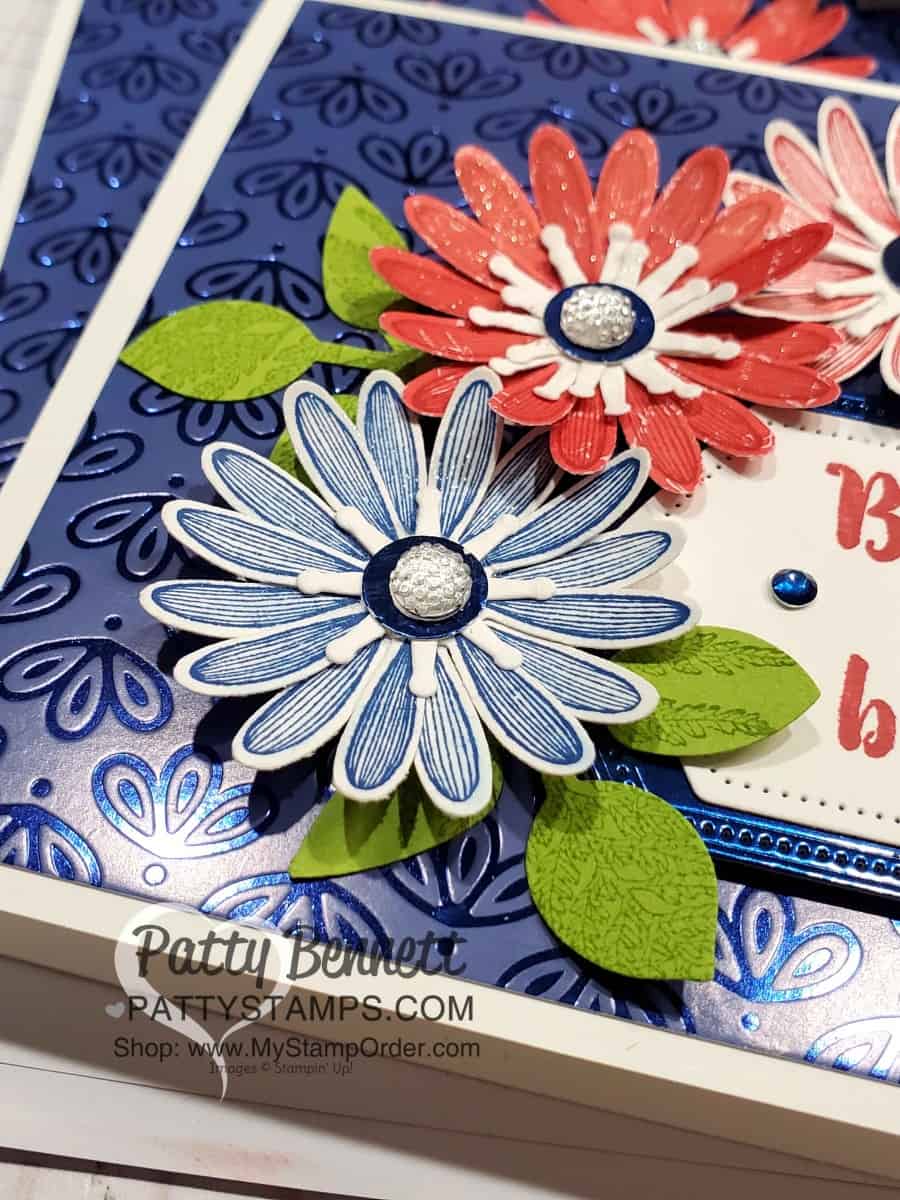 Stampin' Up! Noble Peacock Specialty Foil Paper background. Card idea featuring medium daisy punch in red, white and blue by Patty Bennett, www.PattyStamps.com