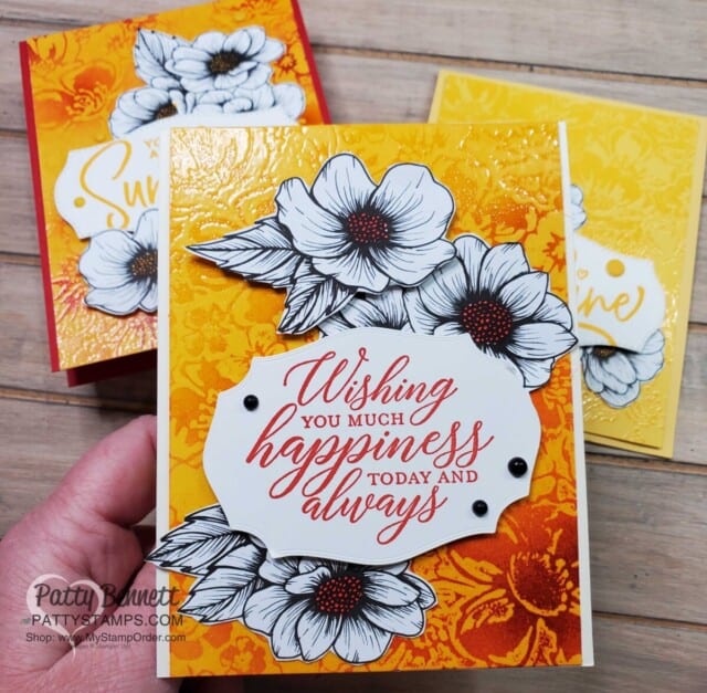 Use the Emboss Resist technique to create card backgrounds with the Wild Rose stamp, Versamark ink and Blending Brushes. True Love Designer paper flowers. by Patty Bennett