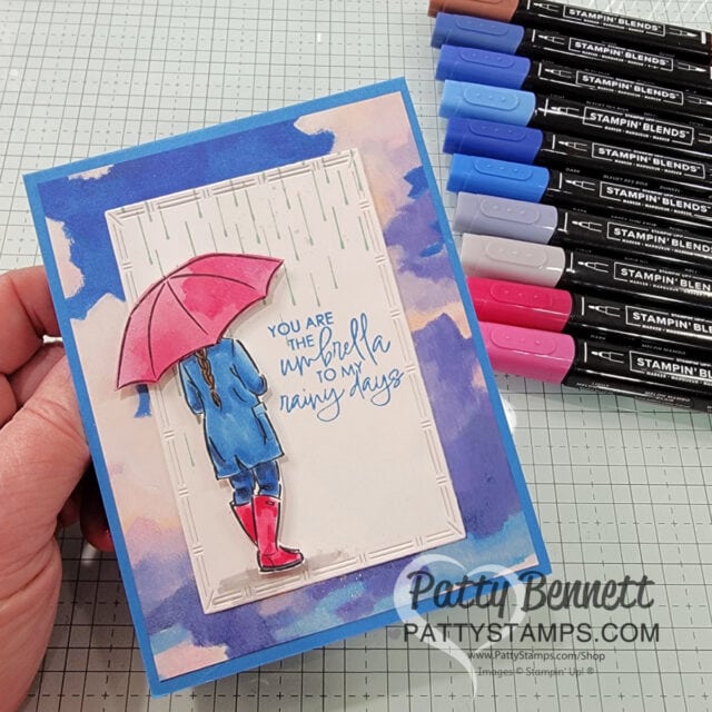 Use the STampin' UP! Everyday Skies 6x6 patterned paper stack for a great background on this Umbrella Days card colored with Stampin' Blend markers. Handmade card idea by Patty Bennett