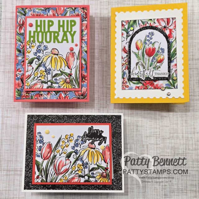 Three floral-themed greeting cards on a wooden surface demonstrating Easy Handmade cards with Memories & More. Top left card says "Hip Hip Hooray" with colorful flowers. Top right card, in yellow, says "Heartfelt Thanks" with an arched floral design. Bottom card says "You Are Amazing" with tulips. Patty Bennett branding is on the bottom right. To read more, visit Patty Stamps (pattystamps.com)