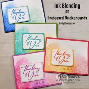 Four handmade cards in blue, green, pink, and orange feature "Thinking of You" messages. Each card has an ink-blended embossed leafy background and a white panel with matching colored text. The caption reads "Ink Blending on Embossed Backgrounds. To read more, visit Patty Stamps (pattystamps.com)