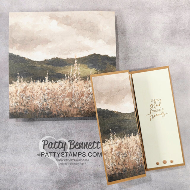 A handmade card with a nature scene showing hills, a cloudy sky, and wild grasses. The card opens partially to reveal the message “I’m so glad we’re friends” in elegant script. The card is signed “Patty Bennett, Pattystamps.com.”. To read more, visit Patty Stamps (pattystamps.com)