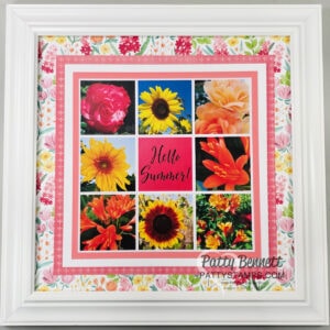 A white-framed collage features nine square panels with colorful summer flowers—roses, sunflowers, and daisies—around a central panel that says "Hello Summer!" in pink. The background and matting have pink and floral patterns. To read more, visit Patty Stamps (pattystamps.com)