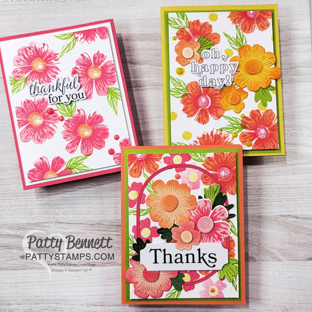 Three handmade floral greeting cards are displayed on a wooden surface. Each features bright red, orange, and pink flowers with green leaves. Sentiments read "thankful for you," "oh, happy day!" and "Thanks." The cards have vibrant, colorful borders. To read more, visit Patty Stamps (pattystamps.com)