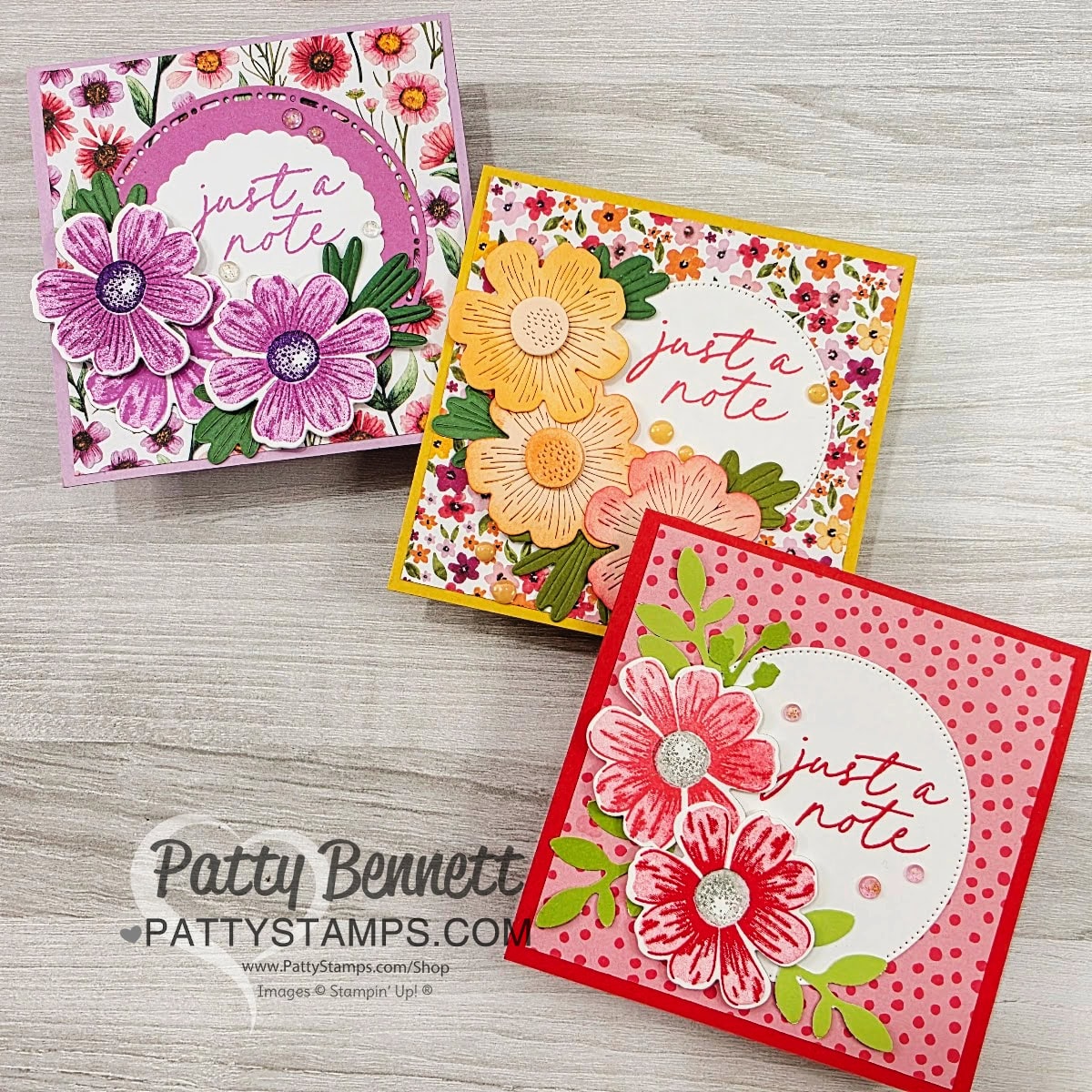 Three square handmade cards with floral designs and the phrase “just a note” in cursive. The top left card is purple-themed, the top right is yellow-orange, and the bottom right is red-pink. All are displayed on a light wood surface. To read more, visit Patty Stamps (pattystamps.com)