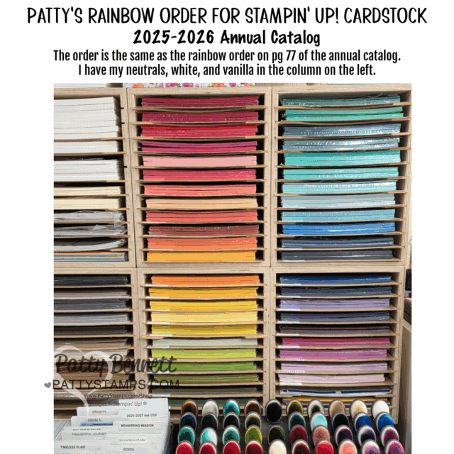 A photo of shelves holding neatly stacked Stampin' Up! cardstock sorted by color in a rainbow order. The left column holds neutral tones, white, and vanilla; the main section displays colored cardstock from red, pink, orange, yellow, green, blue, to purple. To read more, visit Patty Stamps (pattystamps.com)
