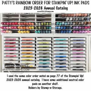 A neatly organized shelf displays Stampin’ Up! ink pads in rainbow order, labeled with color names. Each row features a gradient of hues, including pinks, reds, oranges, yellows, greens, blues, purples, browns, and neutrals, arranged in labeled white holders. To read more, visit Patty Stamps (pattystamps.com)