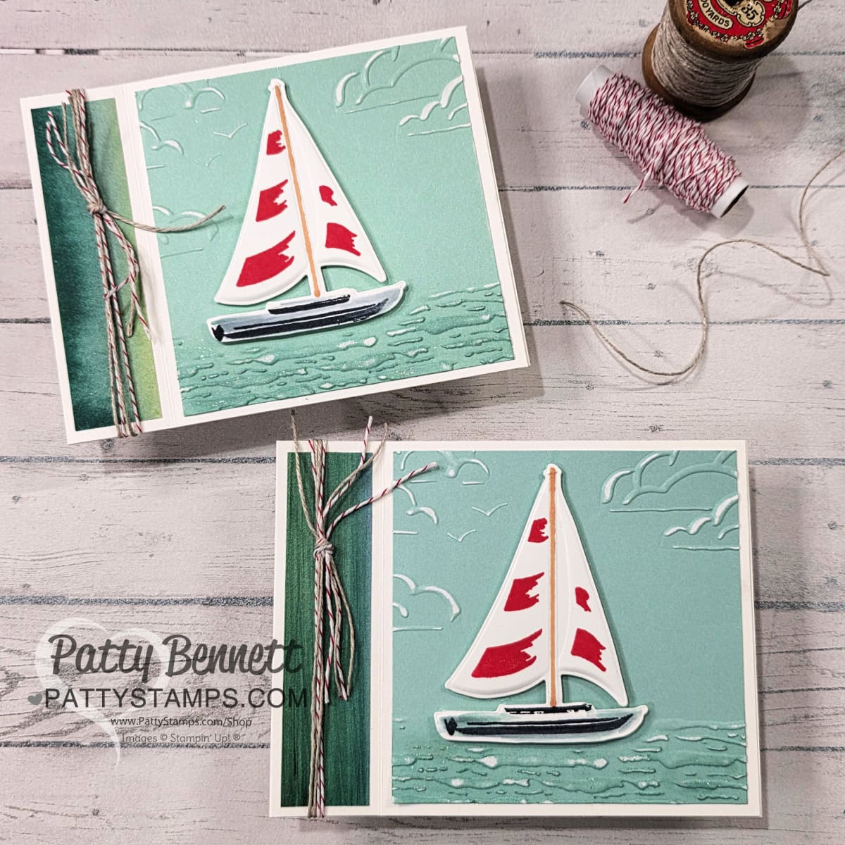 Two handmade greeting cards with a sailboat design feature red-sailed boats on teal water, embossed clouds, and twine tied along the left edge. A spool of red-and-white baker's twine is nearby on a wooden plank surface. "PattyStamps.com" is stamped on one card. To read more, visit Patty Stamps (pattystamps.com)