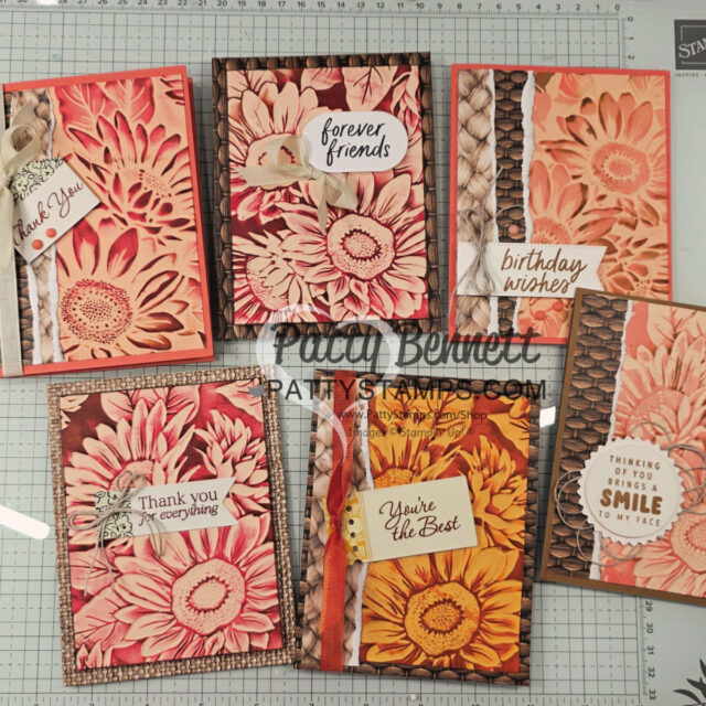 Six handmade greeting cards, each featuring large, embossed daisy designs in warm tones of peach, orange, and yellow. The cards display various messages, including "Thank You," "forever friends," "birthday wishes," and "You're the Best," with ribbon and textured backgrounds. To read more, visit Patty Stamps (pattystamps.com)