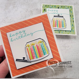 Two handmade Square birthday card ideas are shown. The front card features a striped orange background and a stamped image of candles in a fishbowl, with "happy birthday" written above. The second card in the back has a green pattern and a similar design. To read more, visit Patty Stamps (pattystamps.com)