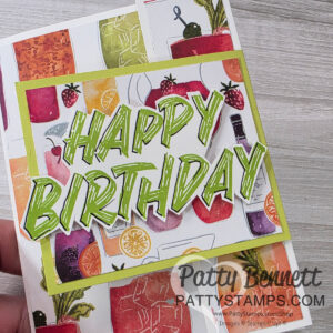 A handmade card with colorful fruit drinks, wine bottles, and glasses in the background. Bold green “Happy Birthday” text is layered on top. The card features vibrant fruit illustrations and has the watermark “Patty Bennett PattyStamps.com.”. To read more, visit Patty Stamps (pattystamps.com)