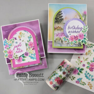 Thoughtful Journey Arch cards. Two handmade greeting cards are displayed on a grey surface. Each features colorful floral designs, arch-shaped frames, and text: “just a note” and “birthday wishes.” Decorative floral paper, a floral-patterned roll, and a “PattyStamps.com” tag are also visible. To read more, visit Patty Stamps (pattystamps.com)