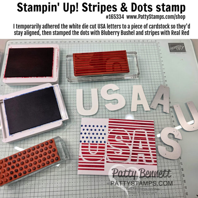A crafting workspace displays "USA" die-cut letters, some inked red and blue with stripes and dots using Stampin' Up! stamps and ink pads. The workspace also shows clear blocks, ink pads, and stamps, with instructions written at the top. To read more, visit Patty Stamps (pattystamps.com)