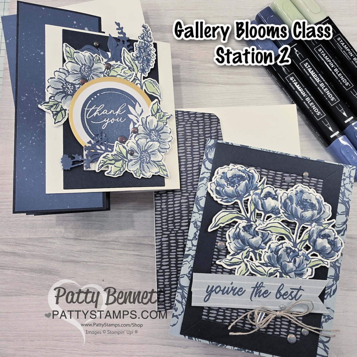 Two handmade floral greeting cards in blue and white tones sit on a wooden table. One card says “thank you,” the other says “you’re the best.” Stampin’ markers, striped and mesh-patterned papers, and branded Patty Bennett labels are visible nearby. To read more, visit Patty Stamps (pattystamps.com)