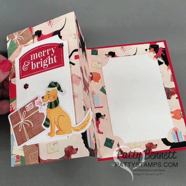 A handmade holiday card opens to reveal a festive design with dog illustrations, colorful envelopes, and gift motifs. The left side features a “merry & bright” sign and a dog with a letter, while the right side has a blank white panel for a message. To read more, visit Patty Stamps (pattystamps.com)