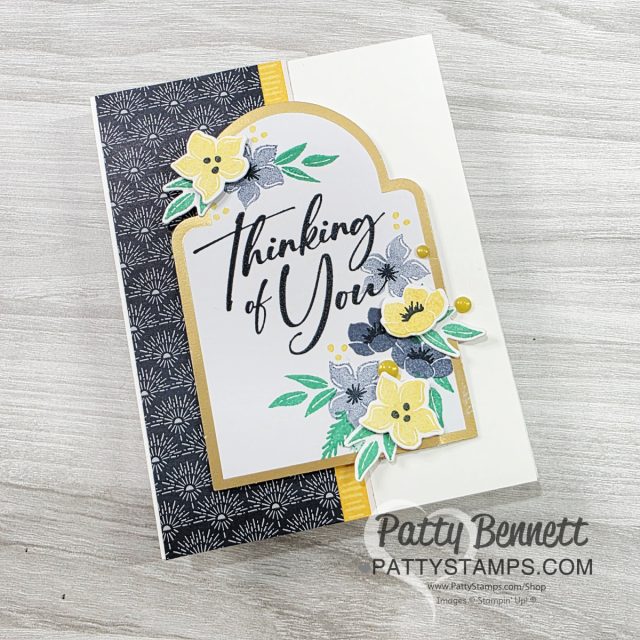 Floral Card with Christmas Greenery bundle from Stampin' Up! A handmade greeting card with “Thinking of You” in elegant script. The card features yellow, black, and blue floral designs, a gold border, and a black-and-white floral patterned panel. "Patty Bennett PATTYSTAMPS.COM" is printed on the bottom right. To read more, visit Patty Stamps (pattystamps.com)
