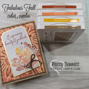 A handmade fall-themed card with autumn leaves and "Expressing heartfelt gratitude" text sits next to four stacked ink pads in shades Cajun Craze, Timid Tiger, Crushed Curry, and Pecan Pie. “Fabulous Fall color combo” text is shown above. To read more, visit Patty Stamps (pattystamps.com)