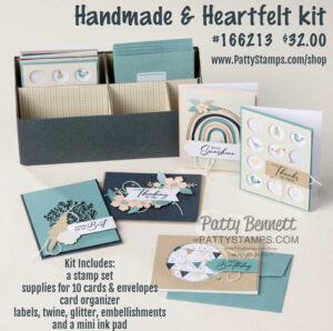 A handmade card kit is displayed with a blue organizer box holding cards and envelopes. Four finished cards with nature and gratitude themes, plus supplies like stamps, twine, labels, and a mini ink pad, are arranged in front. Text details the kit contents and price. To read more, visit Patty Stamps (pattystamps.com)