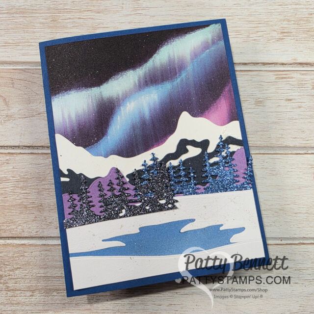 A card with a snowy landscape and northern lights. To read more, visit Patty Stamps (pattystamps.com)