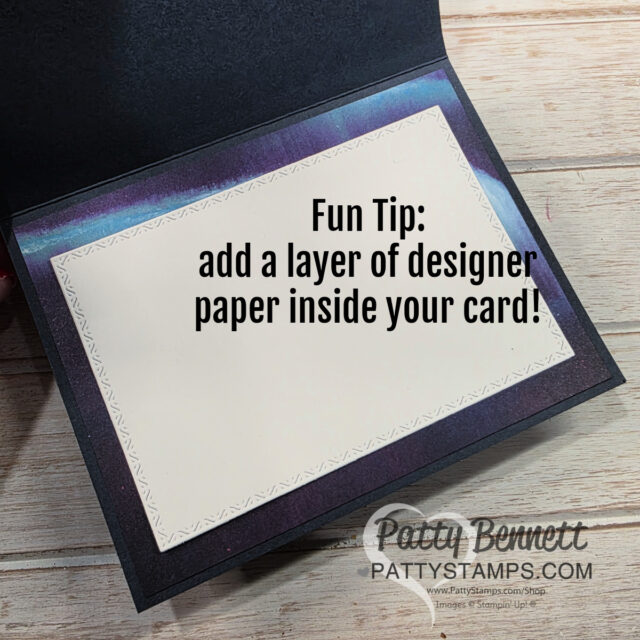 An open handmade card shows a cream-colored inner panel bordered with a subtle pattern, set against a dark, blended background. The text on the panel reads: “Fun Tip: add a layer of designer paper inside your card!” The Patty Stamps watermark is at the bottom. To read more, visit Patty Stamps (pattystamps.com)