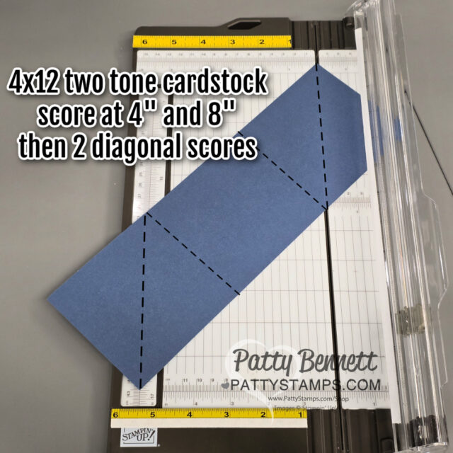 A blue 4x12 two-tone cardstock strip lies on a paper trimmer. The cardstock shows dashed lines at the 4" and 8" marks, and two diagonal dashed lines. Text reads: "4x12 two tone cardstock score at 4" and 8" then 2 diagonal scores. To read more, visit Patty Stamps (pattystamps.com)