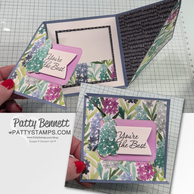 A handmade floral greeting card is shown open and closed. The card features colorful stamped flowers, a pink frame with the text "You're the Best" in script, and decorative patterned paper. A hand holds the card; the PattyStamps.com logo is visible. To read more, visit Patty Stamps (pattystamps.com)