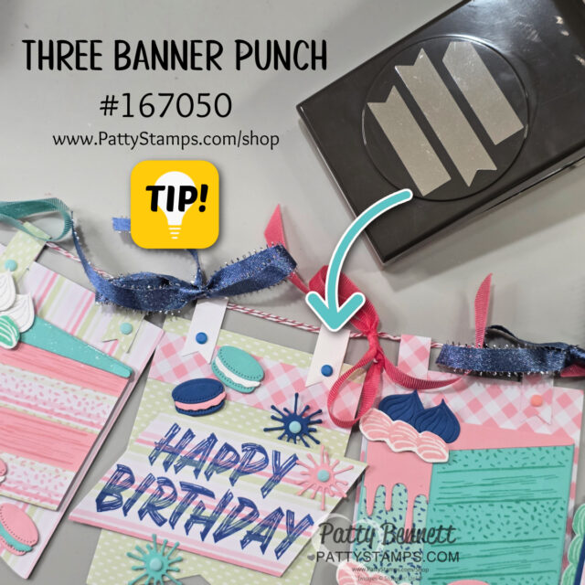 A crafting display features handmade “Happy Birthday” cards decorated with ribbon, macarons, and colorful patterns. An arrow points to a hole in the card, highlighting the use of the Three Banner Punch tool (#167050) shown in the top right. Website: PattyStamps.com. To read more, visit Patty Stamps (pattystamps.com)
