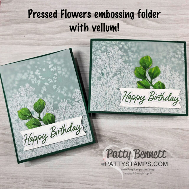 Two handmade birthday cards are shown on a light wood surface. Each card features white embossed floral designs on vellum, green leafy embellishments, and a “Happy Birthday” message. Text above reads, “Pressed Flowers embossing folder with vellum!”. To read more, visit Patty Stamps (pattystamps.com)
