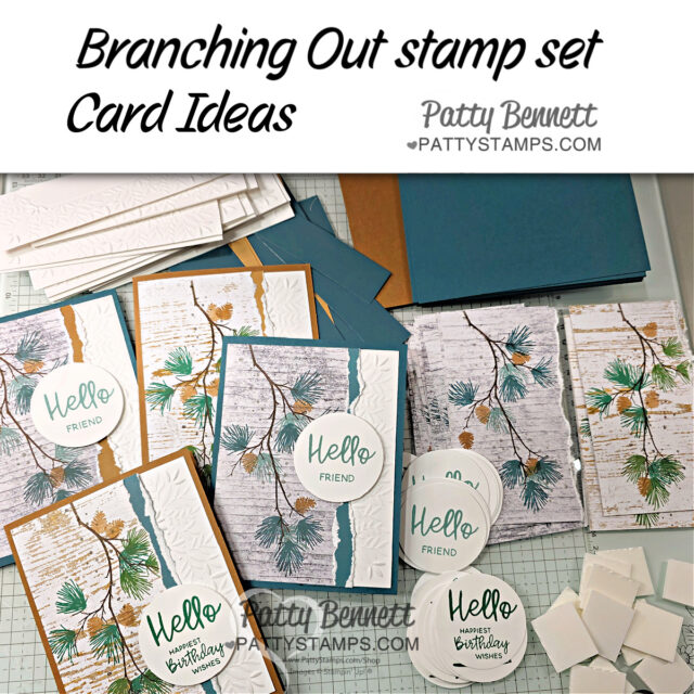 Handmade greeting cards with pine branch designs are arranged on a desk. Stamps say "Hello Friend" and "Happy Birthday Wishes." Supplies including inked cards, cutout sentiments, adhesive foam squares, and blue and white cardstock are visible. Text says "Branching Out stamp set Card Ideas. To read more, visit Patty Stamps (pattystamps.com)
