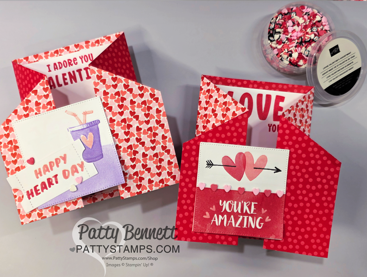 Two handmade Valentine’s Day Fun Fold Cards feature red and pink heart patterns and uplifting messages. One says “Happy Heart Day” with a purple drink; the other, “You’re Amazing,” has arrows and hearts. A dish of colorful sprinkles sits nearby. To read more, visit Patty Stamps (pattystamps.com)