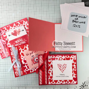 Four handmade Valentine’s Day cards with red, pink, and heart patterns are displayed. One card is open, showing a blank inside. There are white 12x12 papers in the corner, and a grid mat background. “Patty Bennett PATTYSTAMPS.com” is labeled on the photo. To read more, visit Patty Stamps (pattystamps.com)