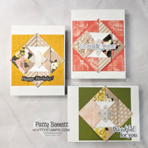 Three handmade greeting cards with layered origami star designs on patterned paper backgrounds. Cards say “Happy Birthday!”, “thank you”, and “thankful for you.” Patty Bennett’s watermark appears at the bottom. Cards are displayed on a light marble surface. To read more, visit Patty Stamps (pattystamps.com)