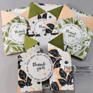 A set of handmade floral thank you cards arranged in a fan shape. Each card features black, white, and peach flowers with green accents and circular “thank you” messages. Some cards have decorative gems and geometric folding. The “Patty Bennett” watermark is visible. To read more, visit Patty Stamps (pattystamps.com)