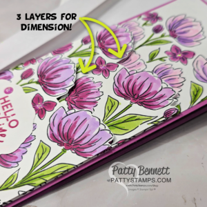 A handmade card with layered, hand-colored purple and pink flowers on a white background. Two yellow arrows point to raised flower petals, with text reading "3 LAYERS FOR DIMENSION!" The card says "Hello" and has a watermark: "Patty Bennett PattyStamps.com. To read more, visit Patty Stamps (pattystamps.com)