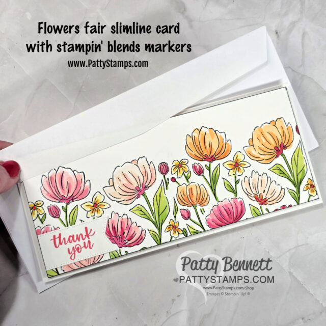 A hand holds a slim, rectangular greeting card with colorful hand-drawn flowers and green leaves. “Thank you” is written in pink script in the bottom left. The card is partially inside a white envelope on a marble surface. Text is above and below the card. To read more, visit Patty Stamps (pattystamps.com)