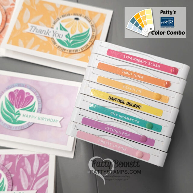 A stack of colorful ink pads labeled with names like “Strawberry Slush,” “Timid Tiger,” and “Daffodil Delight” sits on a table near handmade greeting cards with vibrant floral designs. A color palette graphic and "Patty's Color Combo" appear in the top right corner. To read more, visit Patty Stamps (pattystamps.com)
