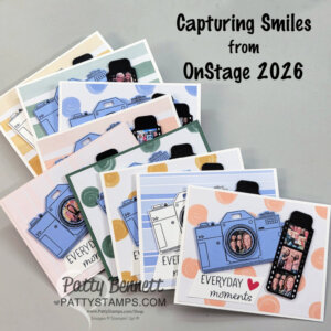 A stack of handmade cards features pastel cameras and faux photos, with the text "Capturing Smiles from OnStage 2026" at the top and "Everyday moments" on each card. The cards are arranged in a fanned-out display on a light surface. To read more, visit Patty Stamps (pattystamps.com)