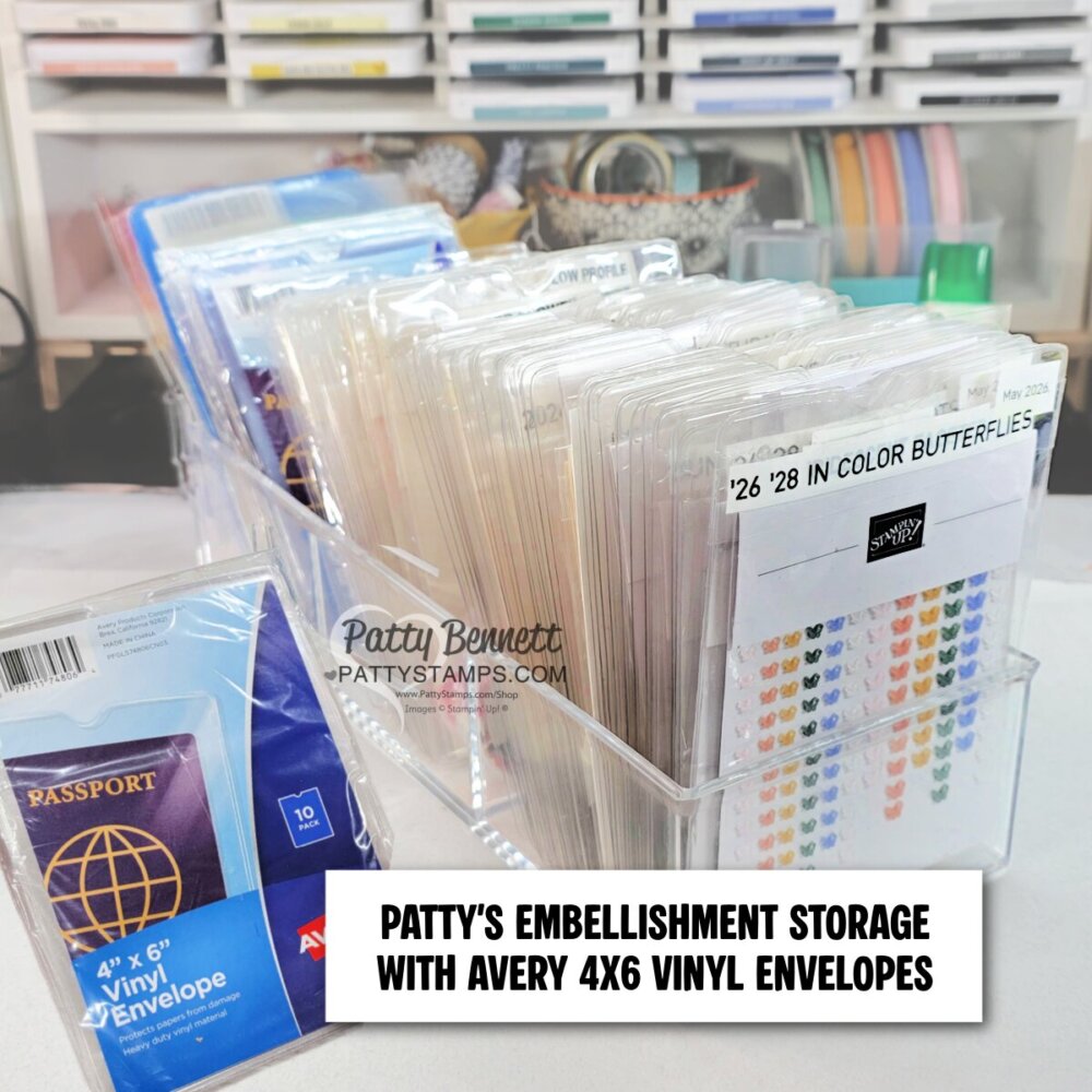 Clear acrylic containers hold neatly organized vinyl envelopes labeled with crafting embellishments. A blue pack of Avery 4"x6" vinyl envelopes is visible on the left. Text overlay reads: “PATTY’S EMBELLISHMENT STORAGE WITH AVERY 4X6 VINYL ENVELOPES.”. To read more, visit Patty Stamps (pattystamps.com)