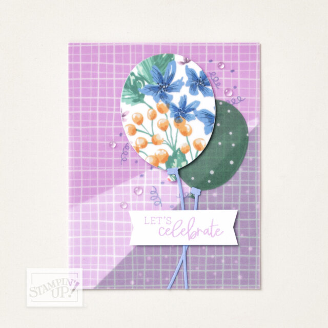 A greeting card with a purple grid background features two balloon shapes—one with a blue and orange floral pattern, the other green with white dots. Below them is a white banner reading “Let’s celebrate” in purple script. The Stampin’ Up! logo is in the corner. To read more, visit Patty Stamps (pattystamps.com)