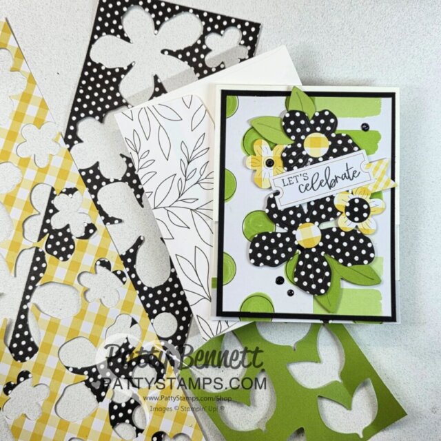 A handmade card features large black, white, and yellow patterned flowers, green leaves, and a "Let's Celebrate" tag. Beside the card are die-cut sheets in polka dot, gingham, green, and white floral patterns on a light surface. To read more, visit Patty Stamps (pattystamps.com)