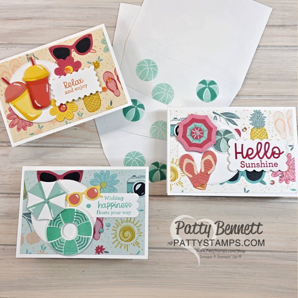 Three handmade summer-themed cards feature bright colors and beach motifs like sunglasses, drinks, umbrellas, and flowers. Each has sunny greetings. An envelope with a beach ball pattern is in the background. “Patty Bennett pattystamps.com” is at the bottom right. To read more, visit Patty Stamps (pattystamps.com)
