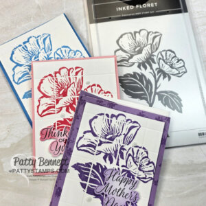 Three handmade cards with large floral designs in blue, red, and purple are displayed. Each card has a thoughtful sentiment and is bordered in matching color. To the right is a black-and-white floral photopolymer stamp set labeled “Inked Floret.”. To read more, visit Patty Stamps (pattystamps.com)