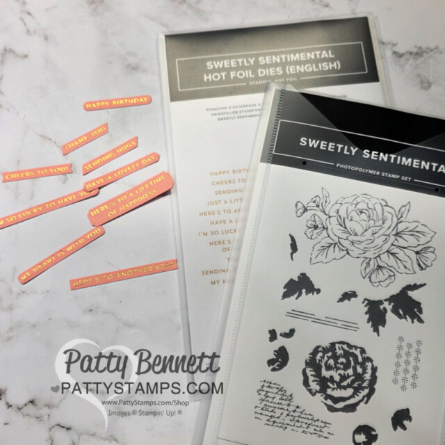 Two "Sweetly Sentimental" crafting sets, one with hot foil dies and one with stamps, are displayed on a marble surface. Around them are pink and gold foil sentiment strips reading phrases like "Happy Birthday" and "Cheers to You. To read more, visit Patty Stamps (pattystamps.com)